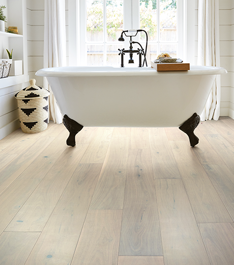 Bathroom with wood-look luxury vinyl flooring from Wholesale Flooring and Blinds in Casper, WY