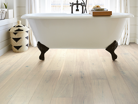 Bathroom with wood-look luxury vinyl flooring from Wholesale Flooring and Blinds in Casper, WY