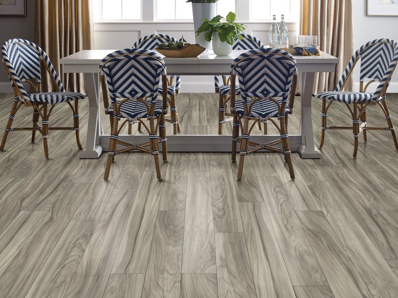 Dining room with wood-look laminate flooring from Wholesale Flooring and Blinds in Casper, WY