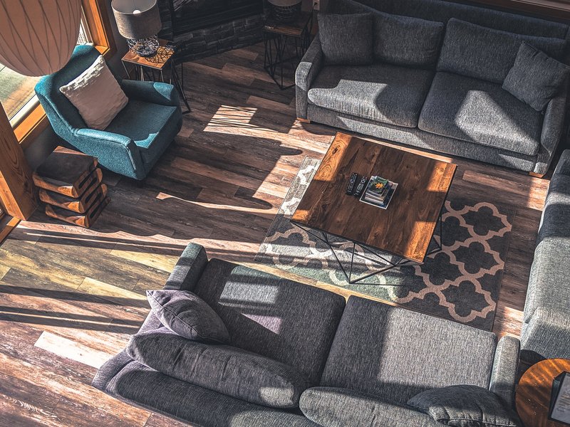 set of grey sofas with wooden coffee table and blue loveseat